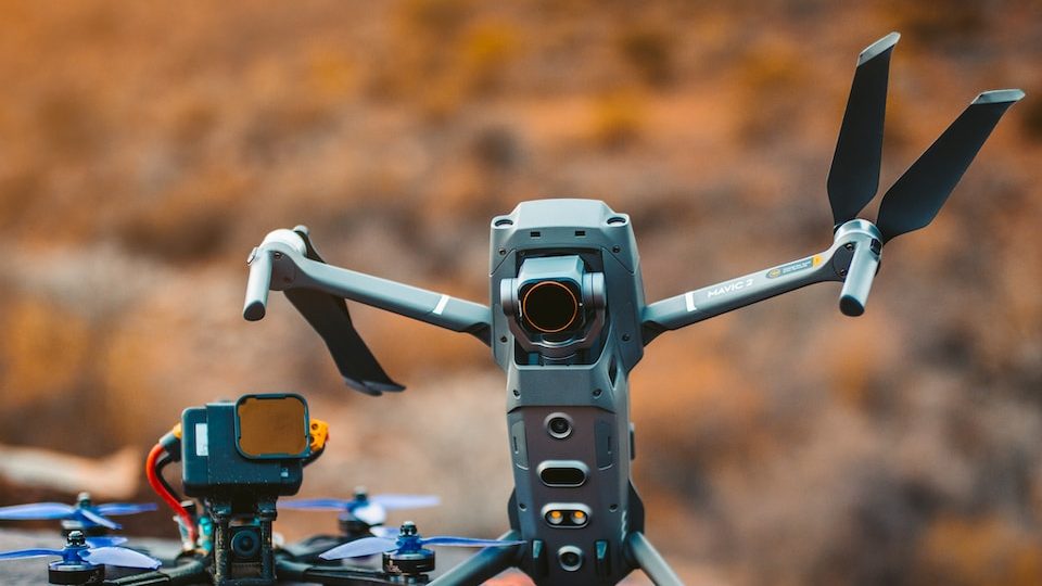 gray and black drone on brown rock during daytime